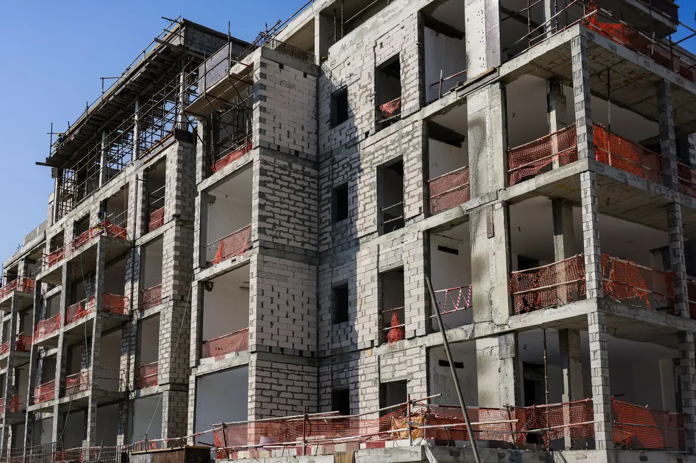 Representative multifamily building under construction; not the offered property, its location, or a proposed design.